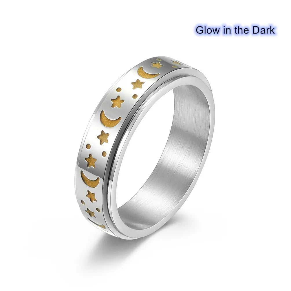 Stainless steel star spinner ring featuring golden moon and star designs that glow in the dark