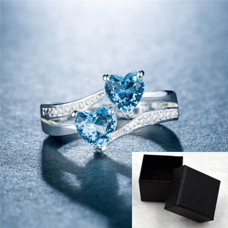 affordable luxury rings for women with heart-shaped blue gemstones and silver band