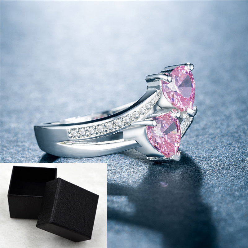 affordable luxury rings for women featuring silver band with pink heart gemstones and small clear crystals