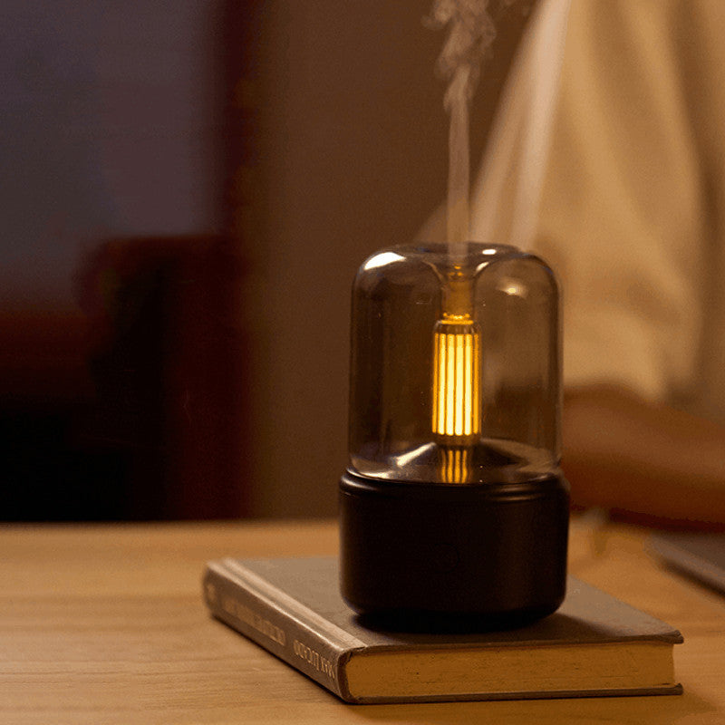 120ml LED nightlight humidifier on a book emitting warm glow and mist for bedside bedroom use