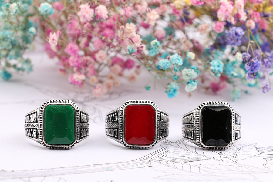CJD display of three vintage men's ring with semi-precious stone options in silver bands with green red and black stones