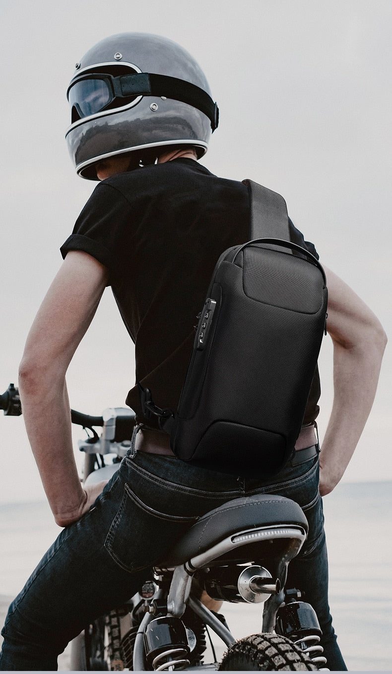 mens backpack sports car-style shoulder bag in black worn as a sling by motorcyclist