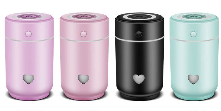 Compact car air purifier in pink, black, and mint colors designed to freshen the air in your vehicle