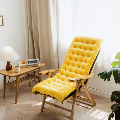 Yellow cushioned cozy chair for reading and relaxation with wooden frame in bright living room