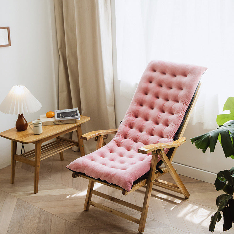 pink cozy chair for reading and relaxation with wooden frame and tufted cushion