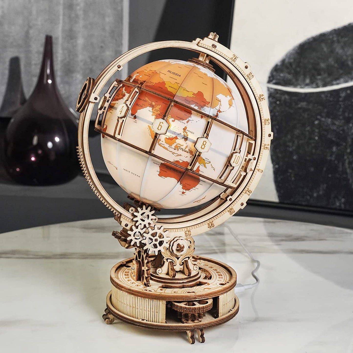 3D wooden globe model kit with intricate mechanical gears and detailed world map on a wooden stand