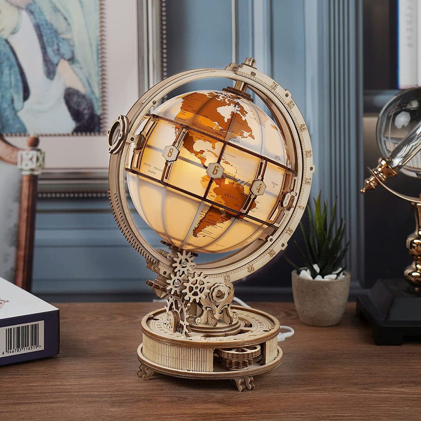 3D wooden globe model kit with intricate gears and illuminated globe on wooden desk