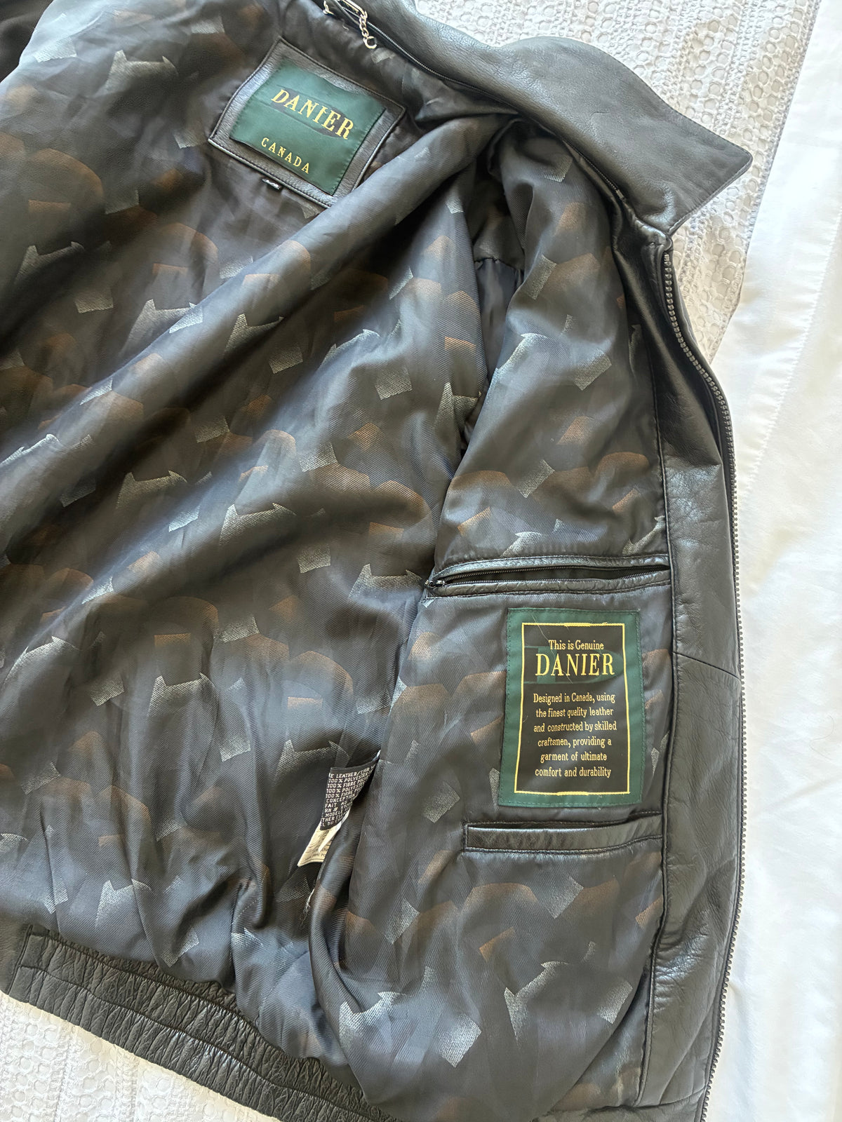 Original interior view of the Danier leather jacket, showing patterned lining and sewn-in labels.
