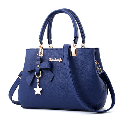 Stylish navy blue handbag with bow detail, perfect as a laptop messenger bag for women