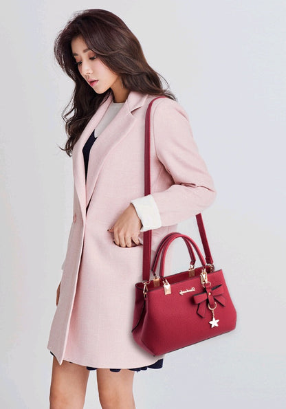 Elegant red handbag with bow detail, perfect as a stylish laptop messenger bag for women