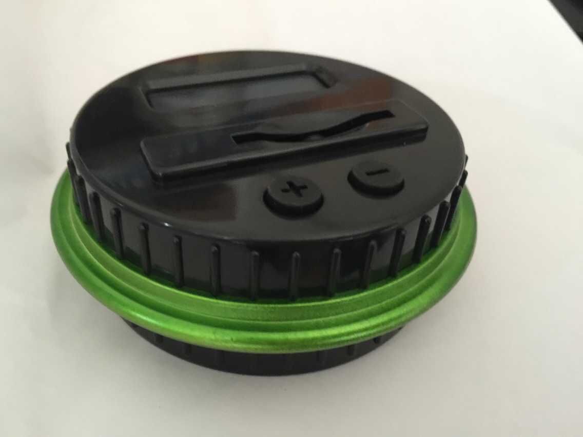 electronic coin counter jar in black and green with a coin slot and buttons for easy counting