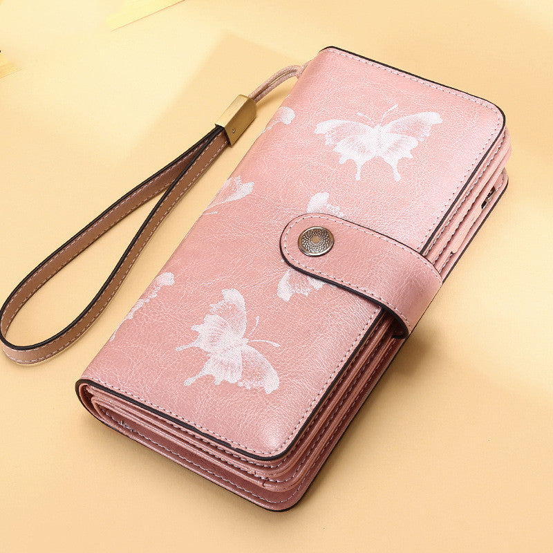 StoreFour elegant leather wallet for women in pink with white butterfly design and wrist strap