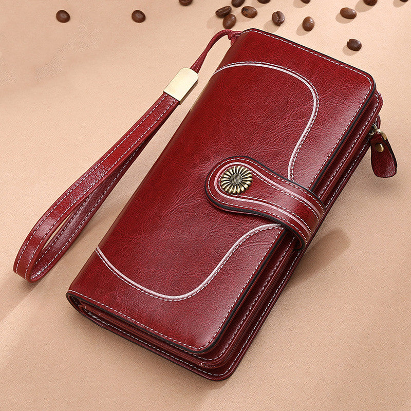 Elegant leather wallet for women mobile phone case in brown with wrist strap and button closure