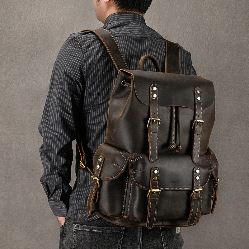 Man wearing a first-layer cowhide adventure backpack with adjustable straps and multiple pockets