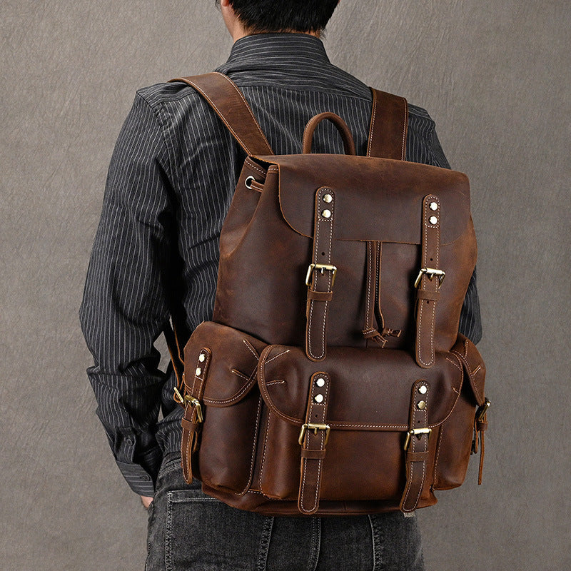 Stylish first-layer cowhide adventure backpack worn by a person with adjustable straps
