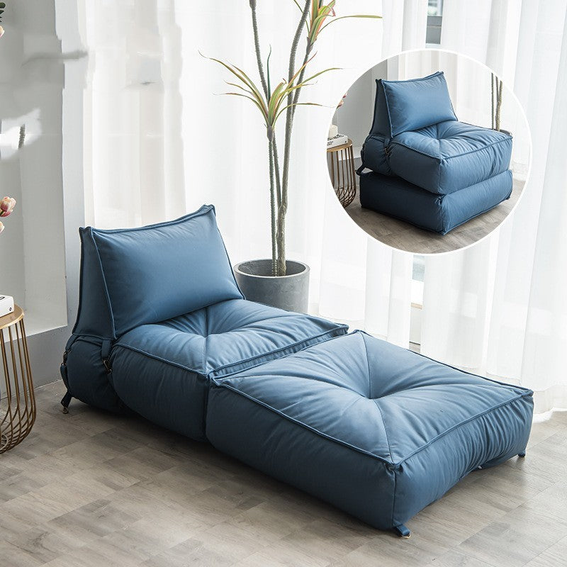 Folding lounge chair for reading in soft blue fabric, perfect for comfortable indoor relaxation