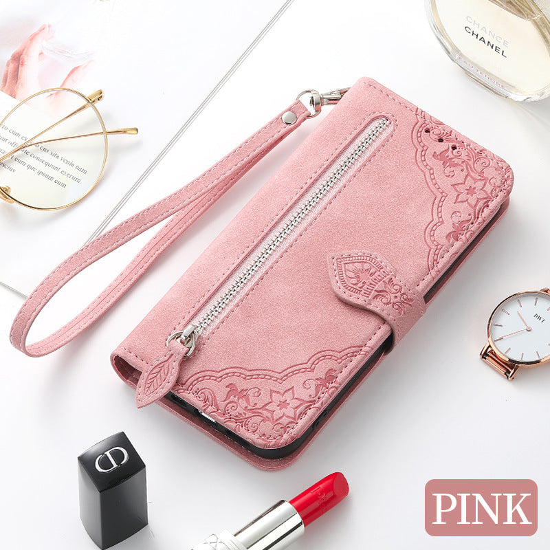 Pink Google Pixel 7 zipper wallet case with embossed floral design and wrist strap for secure carrying