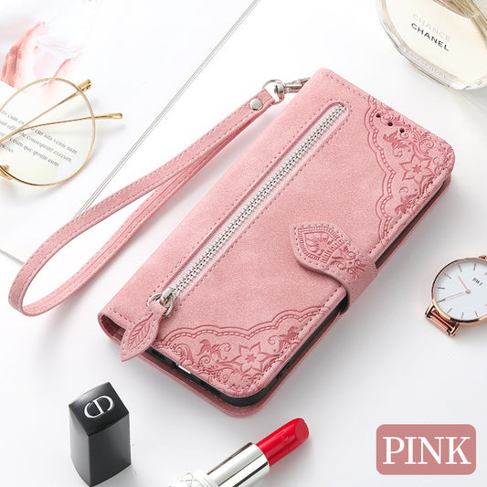 Pink Google Pixel 7 zipper wallet case with embossed floral design and wrist strap for secure carrying
