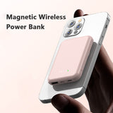 pink magnetic wireless 10000mAh fast charging portable power bank attached to iPhone with LED indicators