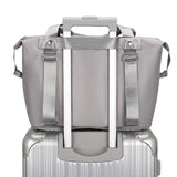 gray compact work backpack for women with luggage sleeve mounted on silver carry on suitcase