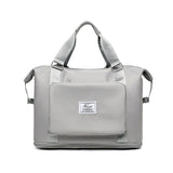 light gray womens backpack with top handles and front pocket compact work backpack for women