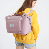 pink rectangular compact work backpack for women on model wearing yellow hoodie and shorts
