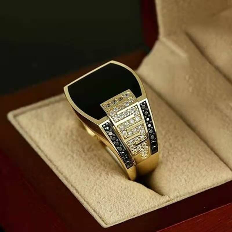 men's elegant black gemstone ring with gold accents and sparkling details in a classy display box