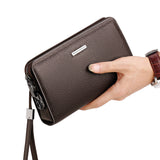 men's leather clutch wallet in brown, featuring a sleek design and convenient wrist strap