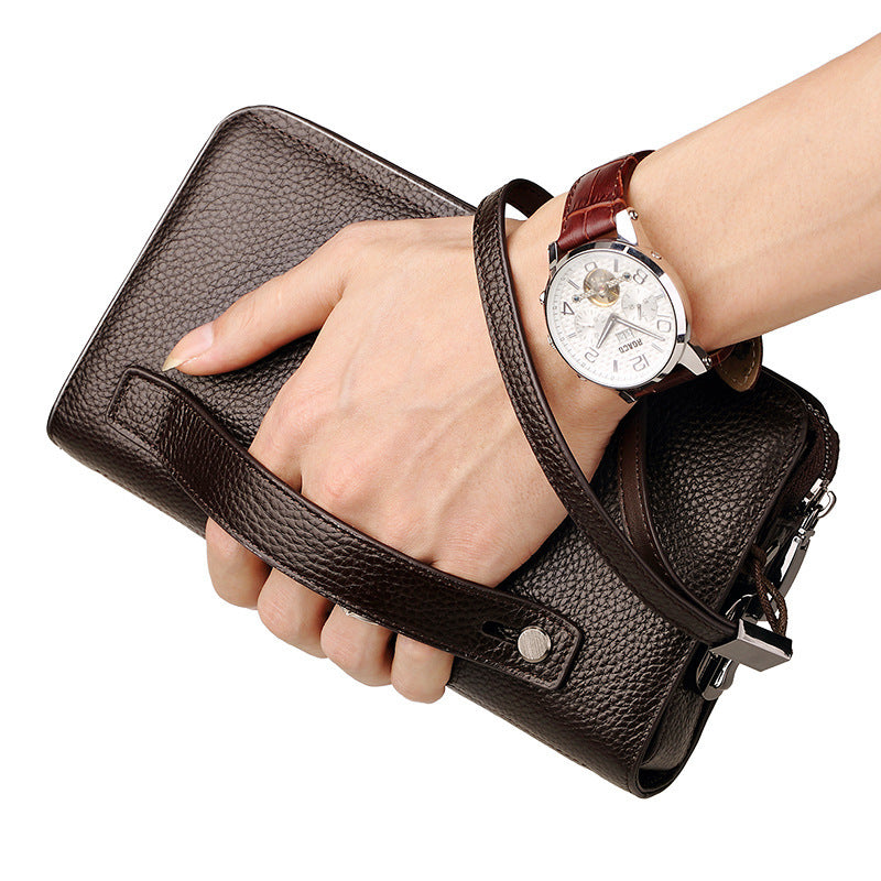 men's leather clutch wallet held in a hand with a stylish watch for a sophisticated look