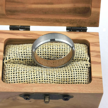 Men's silver tungsten carbide ring displayed in a wooden box with soft padding