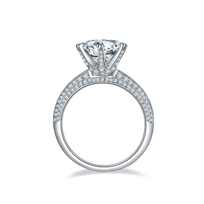 moissanite diamond engagement ring with round center stone and paved band in white metal