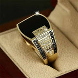 men's elegant black gemstone ring with gold band and sparkling clear stones in jewelry box