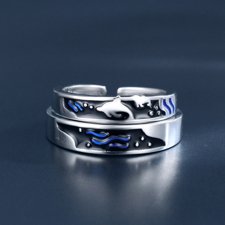 Silver sea themed matching rings for couples featuring dolphin and wave designs