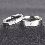 Elegant silver couple ring set featuring a sleek design and a central diamond accent