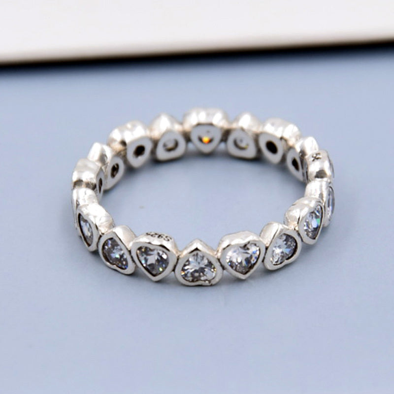 silver heart diamond ring with heart-shaped stones in a sparkling design