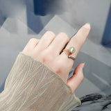Stylish hand wearing a gold simple ring for women with a unique gemstone design