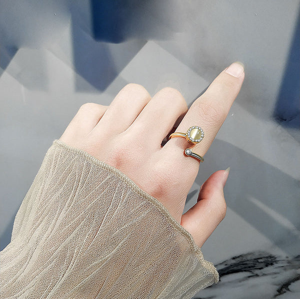 Stylish hand wearing a gold simple ring for women with a unique gemstone design