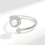 Simple ring for women featuring a central gemstone and sparkling accents on a sleek band
