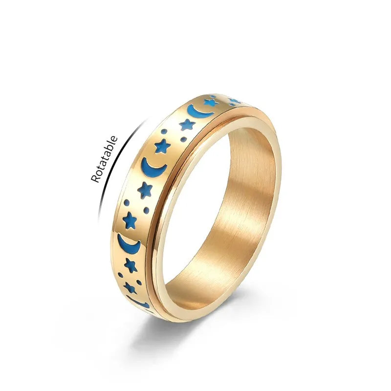 Gold and blue stainless steel star spinner ring featuring moon and star designs for everyday wear