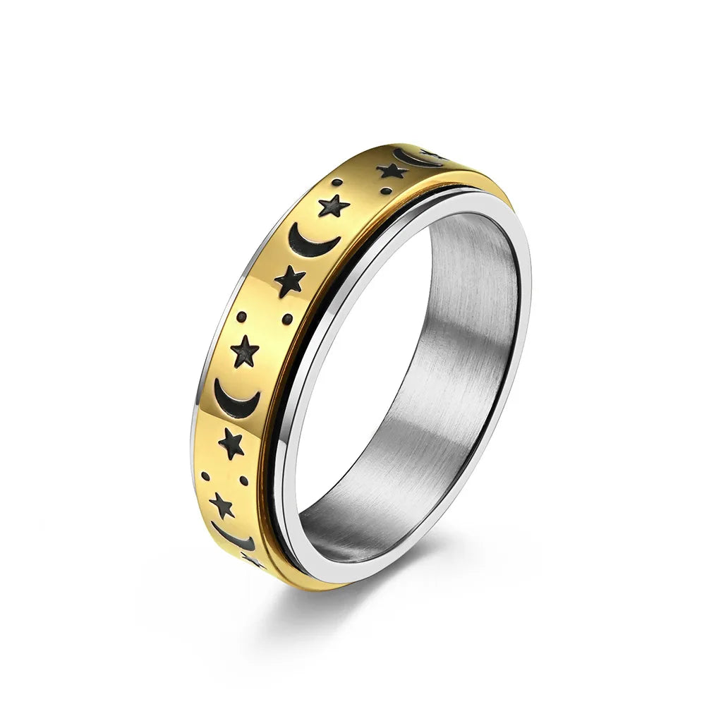 Stainless steel star spinner ring with black moon and star designs on a gold finish