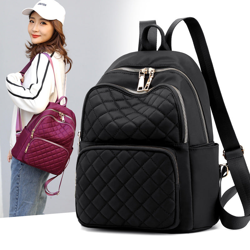 stylish everyday women's backpack in black quilted design with multiple zippered compartments