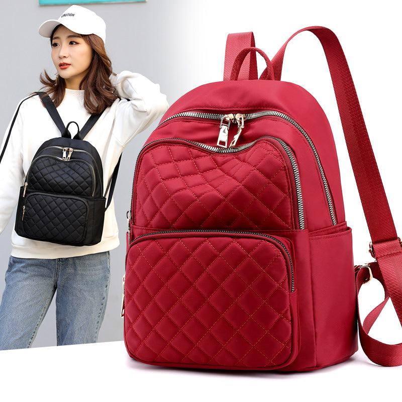 stylish everyday women's backpack in red quilted design with multiple zippered compartments