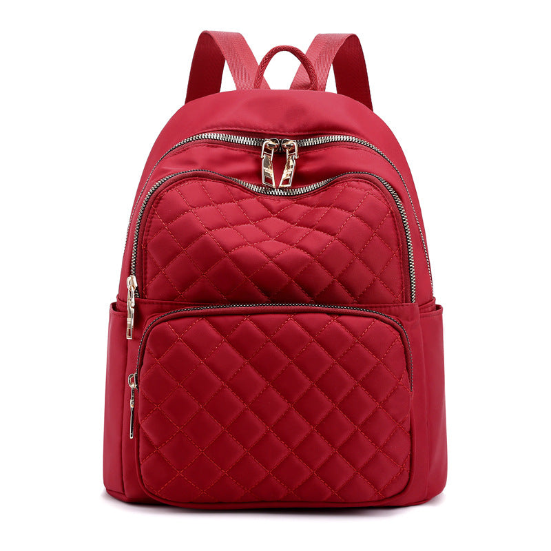 red quilted stylish everyday women's backpack with multiple zippered compartments