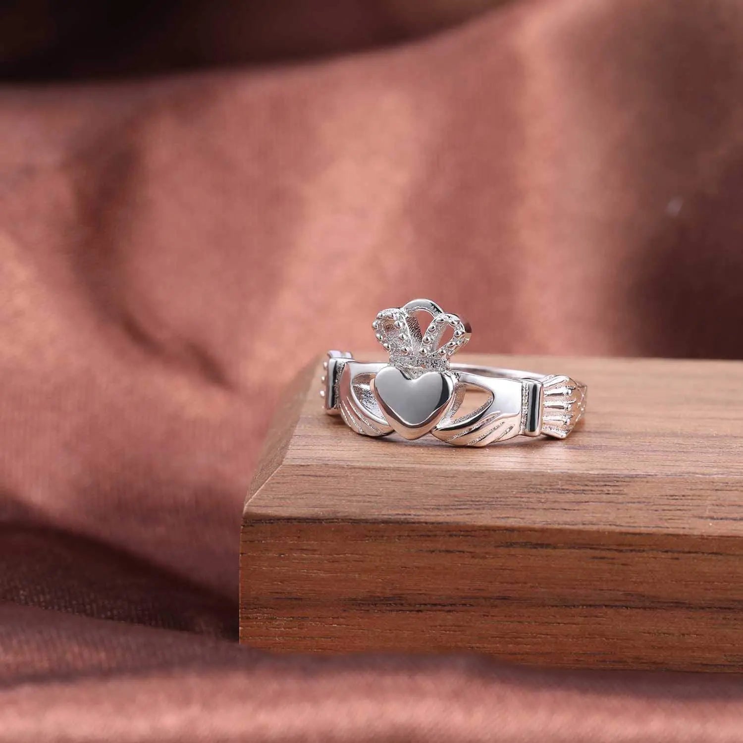 925 sterling silver Irish promise ring for women featuring a heart and crown design on a wooden display