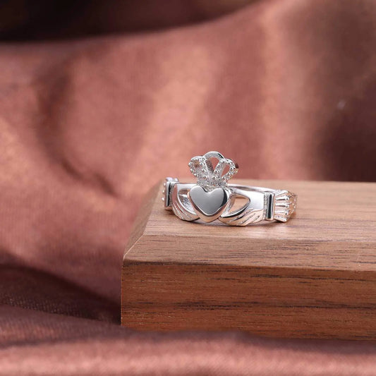 925 sterling silver Irish promise ring for women featuring a heart and crown design on a wooden display