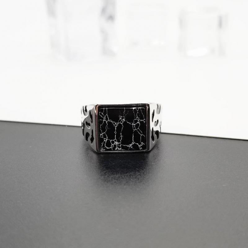 Turkish vintage black stone ring with intricate silver band design on black surface