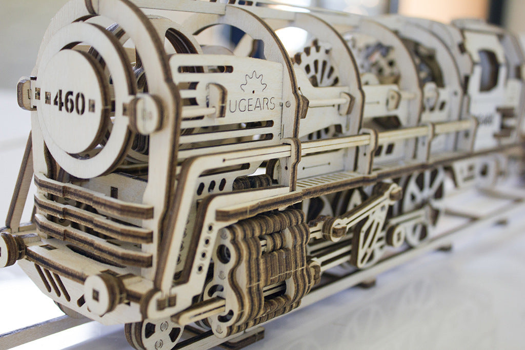 Detailed mechanical locomotive model kit made from laser-cut wood, showcasing intricate design and craftsmanship