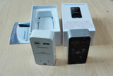 bluetooth wireless laser keyboard projector units in white and black with box and manual on a wood table