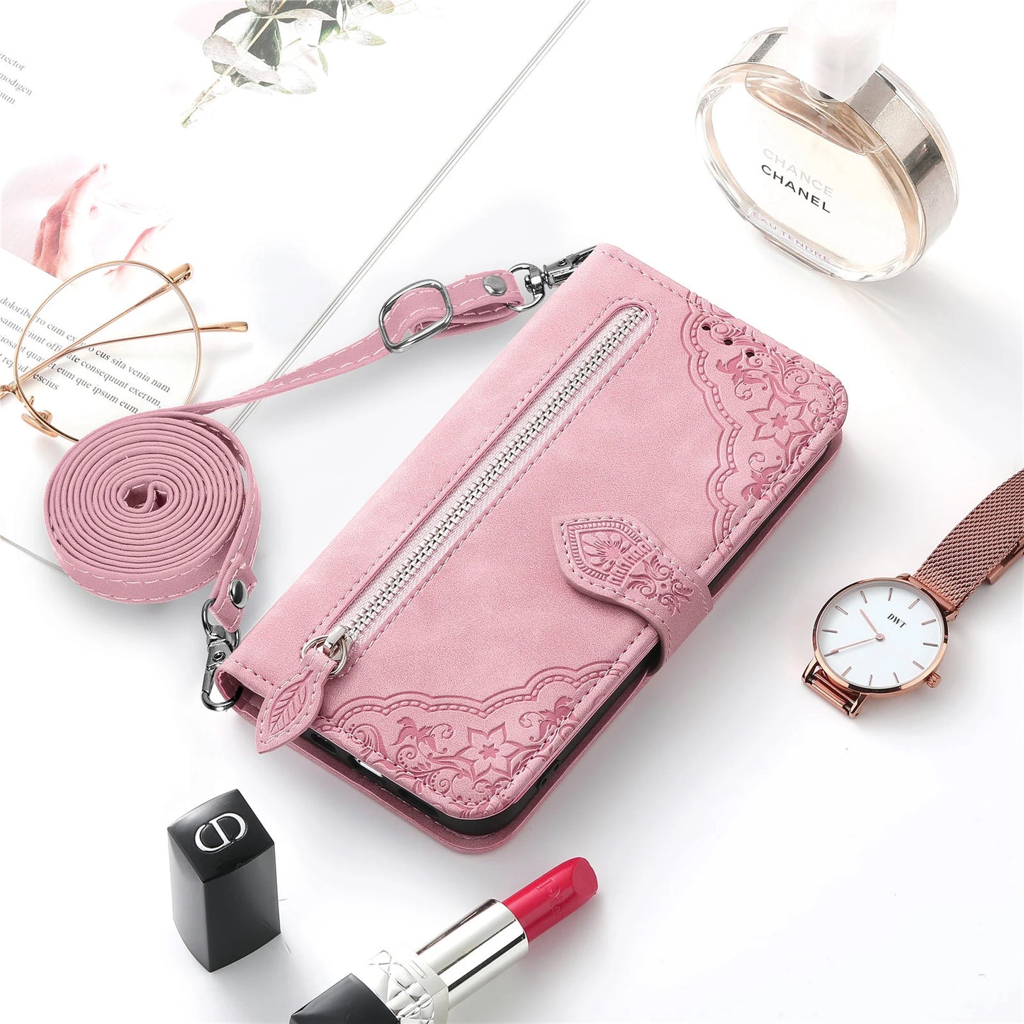Pink wallet case for iPhone 14 13 12 with strap featuring floral design and zipper closure