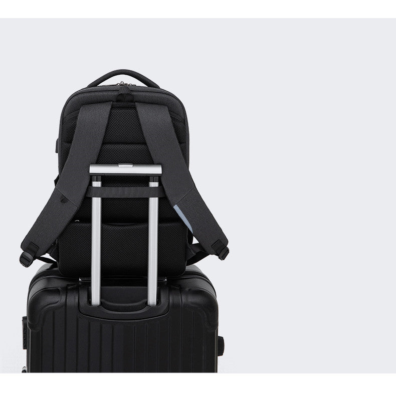 water-repellent business travel backpack securely mounted on a wheeled suitcase